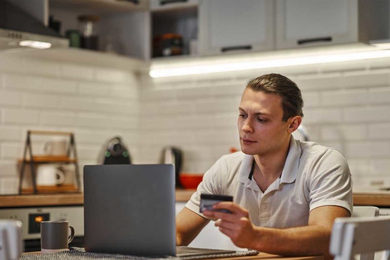Young man looking at laptop