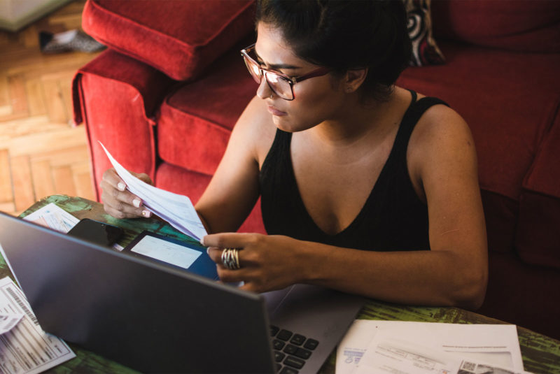 woman at home with bills wondering how to get a personal loan