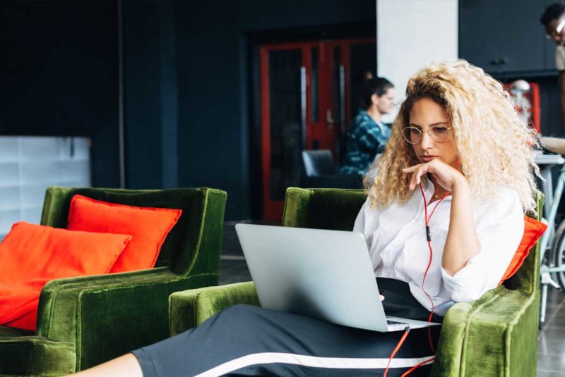Student sitting while working on a laptop